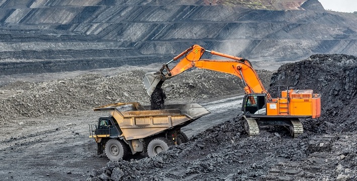Coal mining in a quarry. A hydraulic excavator loads a dump truck.